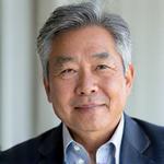 Professional headshot of Dr. Aaron Chen, a composed man in his early 50s, with a thoughtful expression and silver-streaked hair.