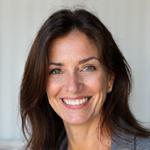Professional headshot of Sofia Martinez, an energetic woman in her early 40s, with a bright smile and vibrant presence.